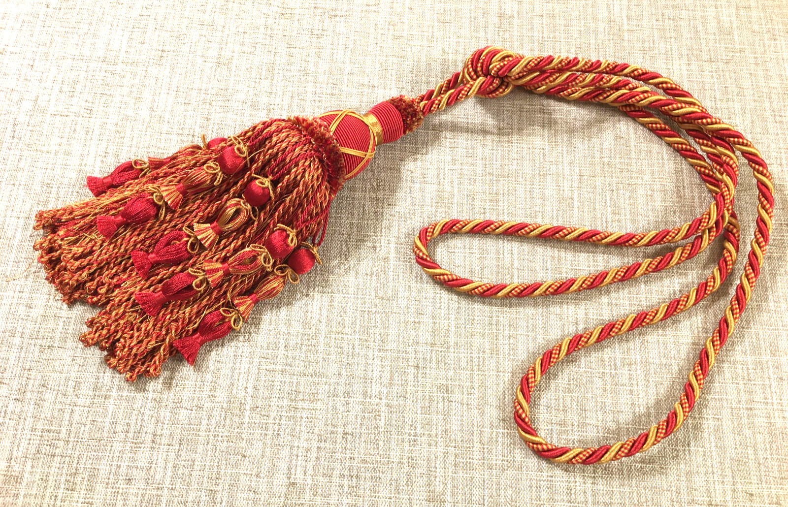braided rope drapery tie back with large tassel gold & red