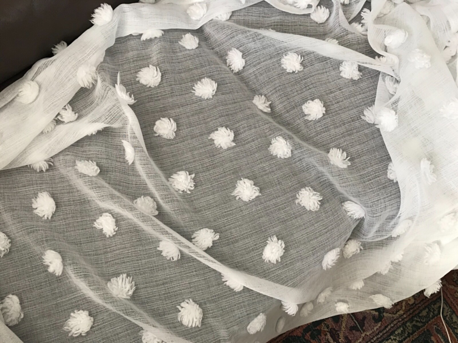 One pack of 2 solid sheer window panels by DKNY white with pompons size 50x 83.5